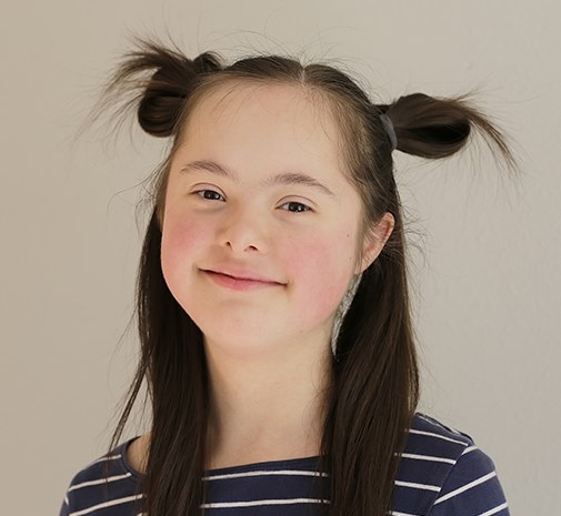 Young girl smiling after special needs dentistry visit