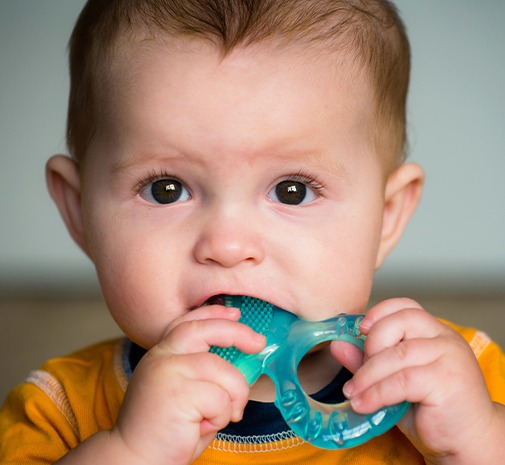 Young child chewing teething toy