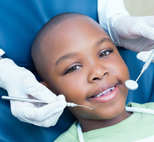 Boy undergoing oral cancer screening in Grayslake