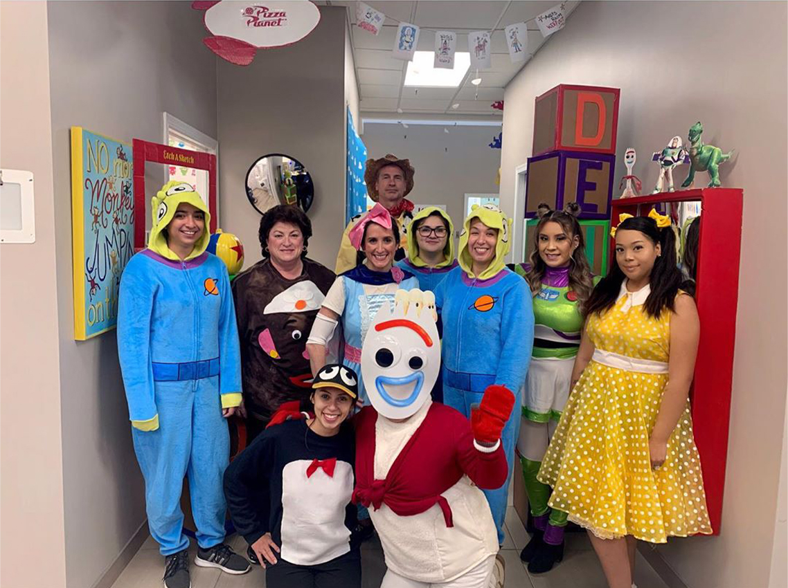 Dental team members in costume to celebrate Halloween