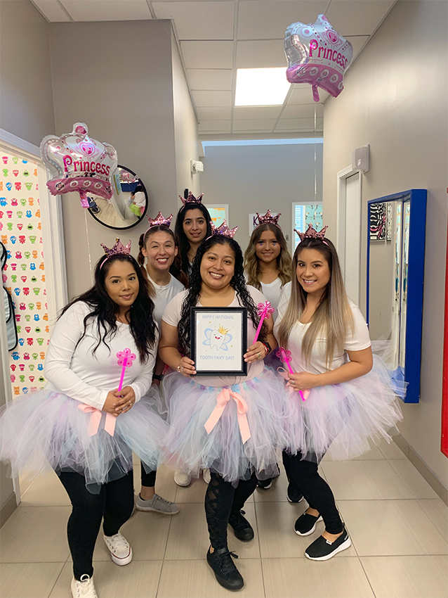Dental team members dressed as fairies for national tooth fairy day