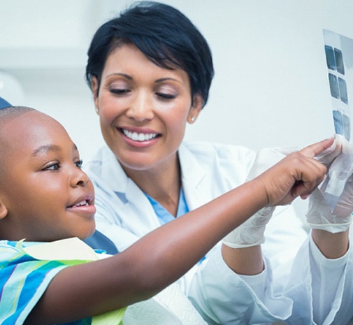 Toddler looking at dental X-rays in Grayslake