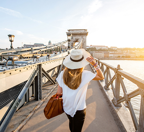 Woman walking on a bridge overlooking water