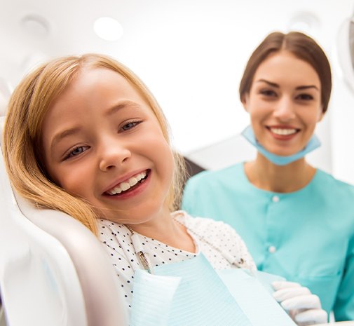 Child and dental team member smiling during children's dental emergency visit