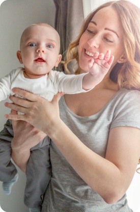 Mother holding baby after infant dental care visit