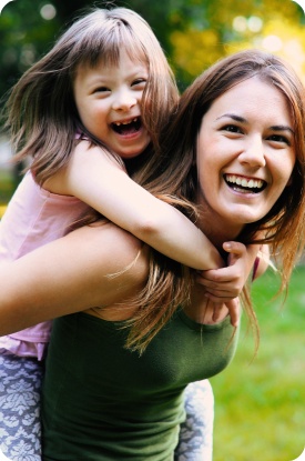 Mother and child laughing after special needs dental care visit