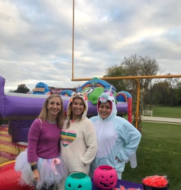 Three team members wearing costumes at community event