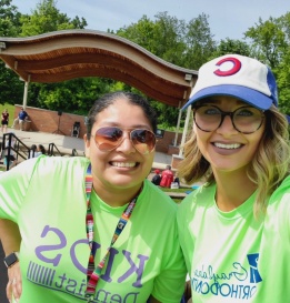 Two smiling dental team members at community event