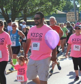 Dental team members in matching shirts participating in a fun run event