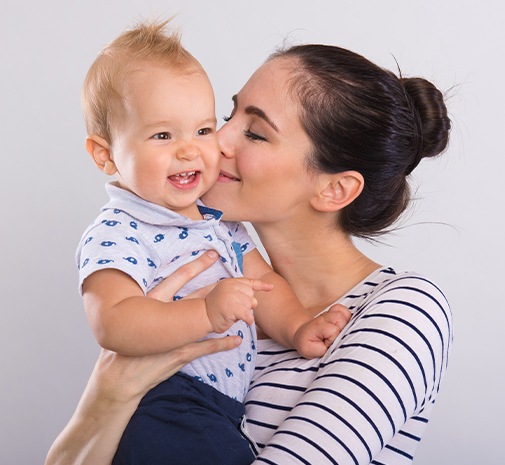 Mother giving baby a kiss on the cheek