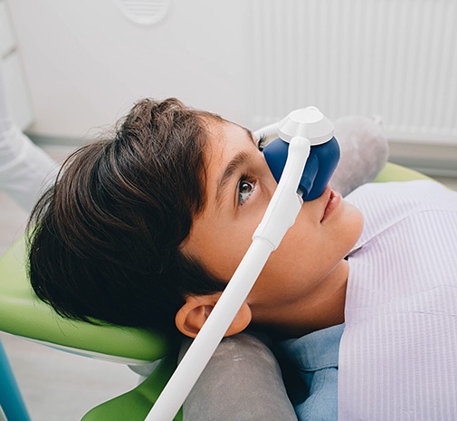 Child with nitrous oxide dental sedation mask