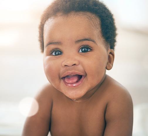 Smiling baby drooling due to teething