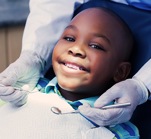Child smiling during pulp therapy visit