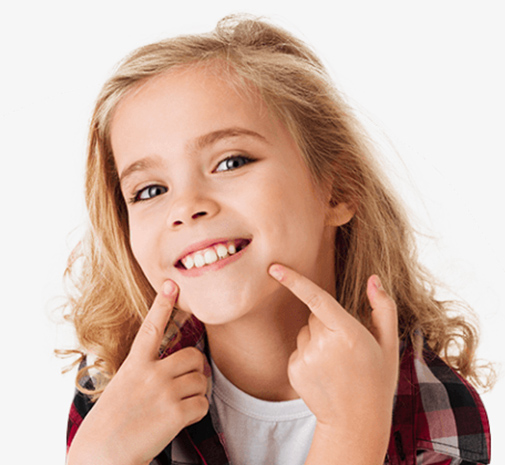 Little girl pointing to her smile after dental crown restorative dentistry
