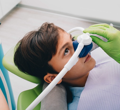 Child with nitrous oxide dental sedation mask in place