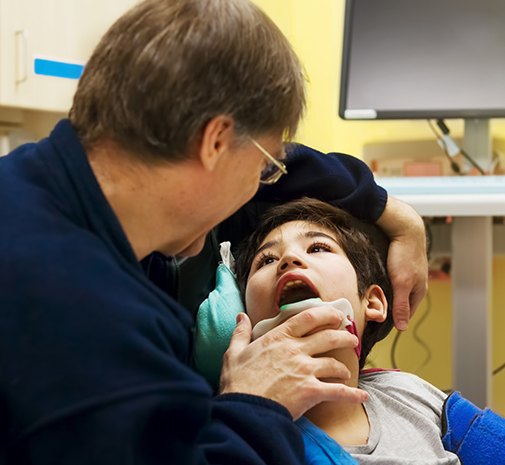 Child receiving special needs dental exam