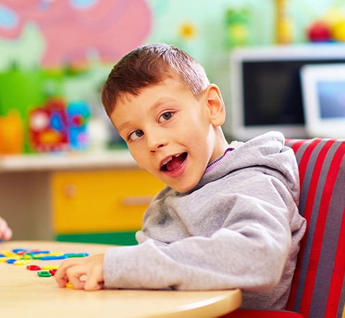 Child smiling after special needs dentistry visit