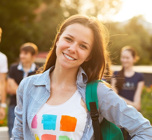 Teen with healthy smile after dentistry for teens