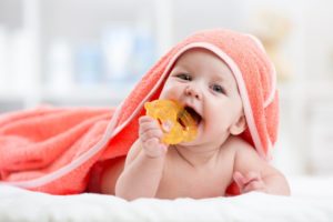 baby chewing on a teether getting their baby teeth