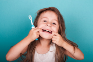 a child brushing her teeth